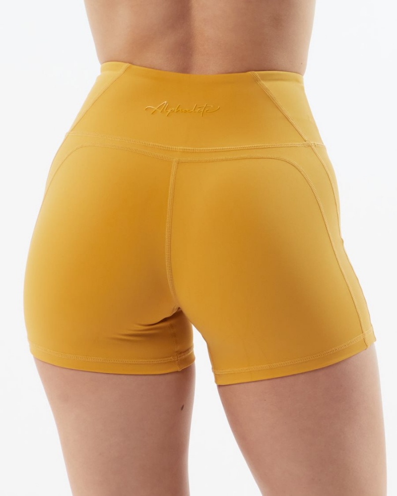 Women's Alphalete Pulse Surge Short 4" Shorts Exotic Yellow | 2097-CHMAI